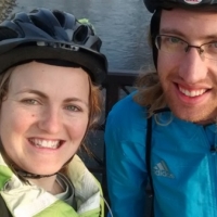 A couple poses for a selfie while on a break from biking.