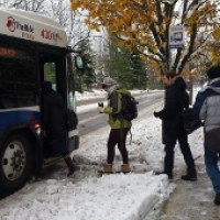Bus riders climb onto the Ann Arbor bus.