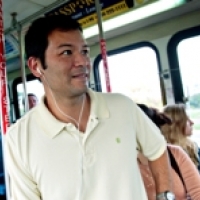 A man waits for his stop on the bus.