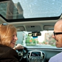 Two carpoolers enjoy each others company.